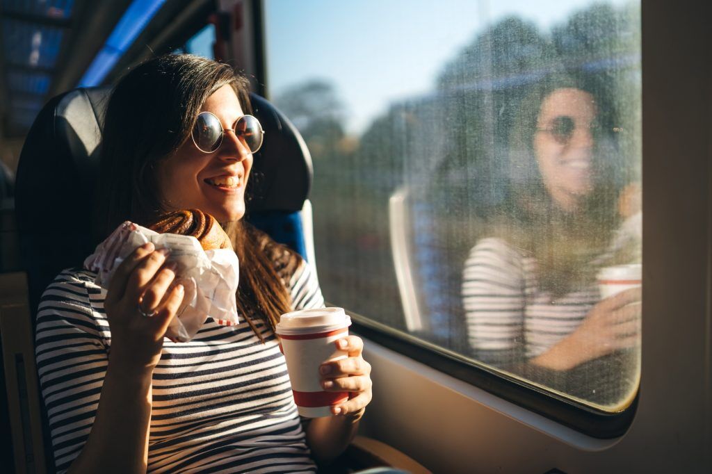 Customer is looking through window on a train ride